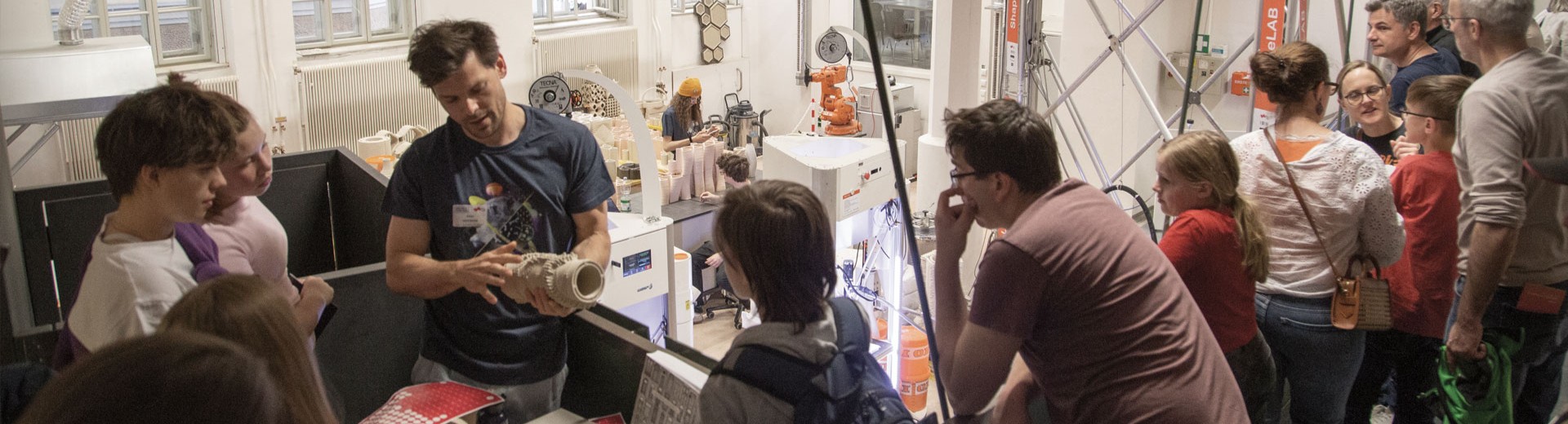 Researcher showing 3D printed artefacts to the public
