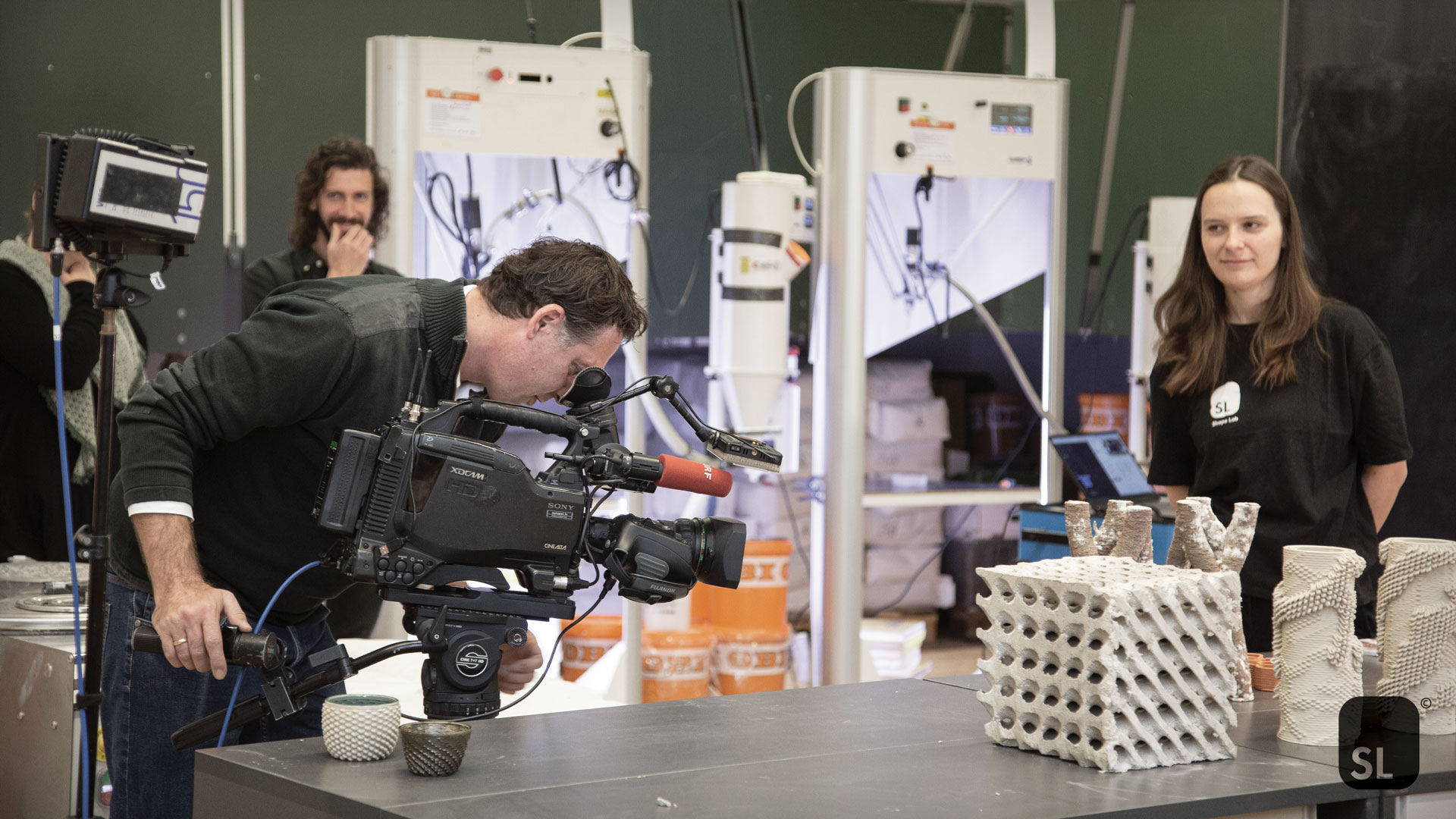 Reporter is filming a 3D print exhibit