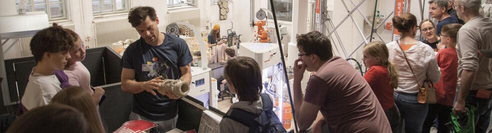 Researcher showing 3D printed artefacts to the public